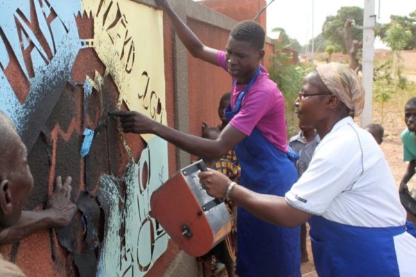 The group created a stencilled picture on the wall of the Delwendé Centre.