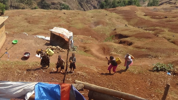 Carrying water from the river to mix mortar.